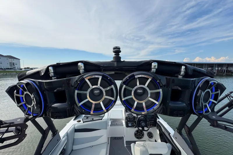 Slide: The Image of 2023 Axis A225 boat with advanced sound system and sleek design on the water. - 24