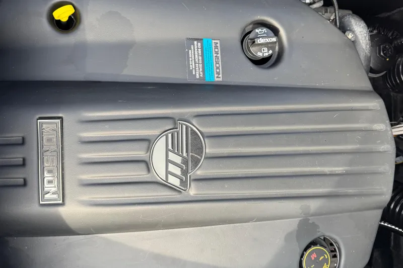 Slide: The Image of 2023 Axis A225 engine cover with Monsoon branding and oil cap details. - 28