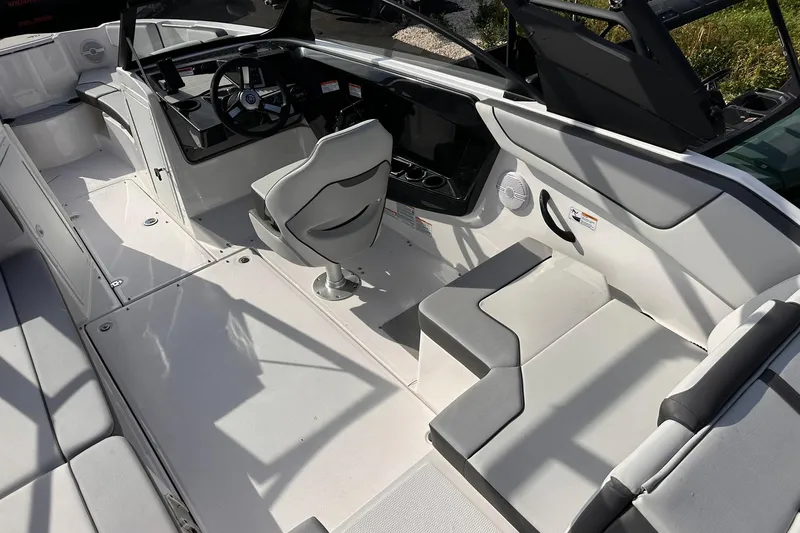 Slide: The Image of 2025 Yamaha Boats AR220 interior with modern seating and steering console. - 12