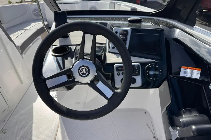 Slide: The Image of 2025 Yamaha Boats AR220 steering console with modern controls and sleek design. - 13