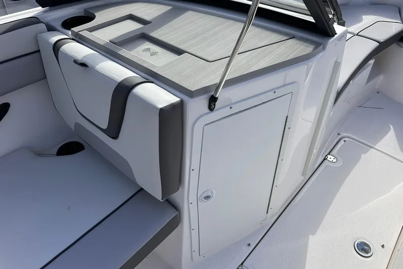 Slide: The Image of 2025 Yamaha Boats AR220 interior with sleek seating and storage compartments. - 14