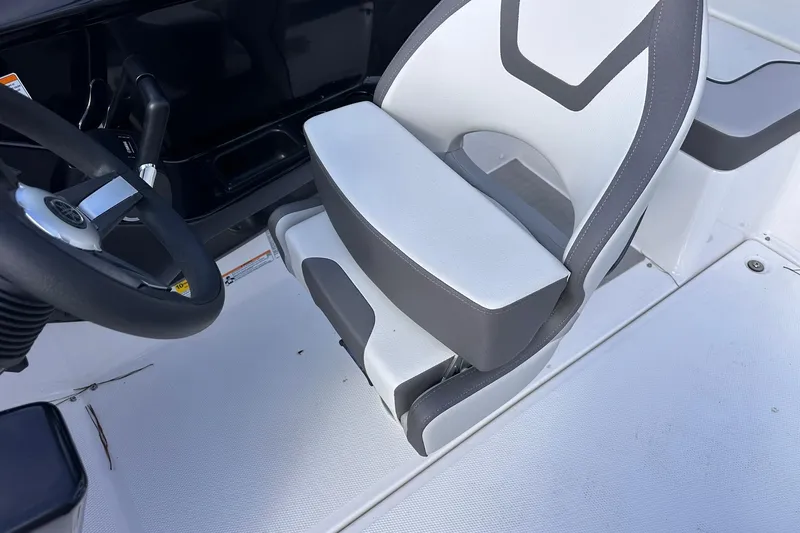 Slide: The Image of 2025 Yamaha Boats AR220 cockpit with steering wheel and cushioned seat. - 19