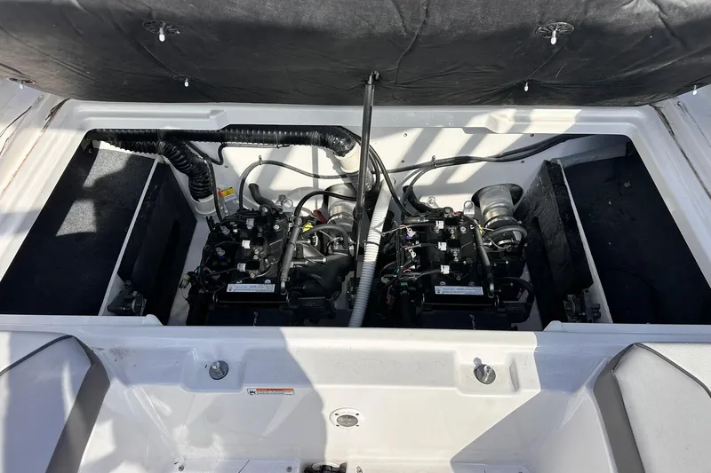 Slide: The Image of 2025 Yamaha Boats AR220 engine compartment with dual engines and wiring. - 22