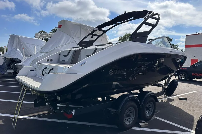 Slide: The Image of 2025 Yamaha Boats AR220 on trailer in parking lot, sleek design, sunny day. - 6
