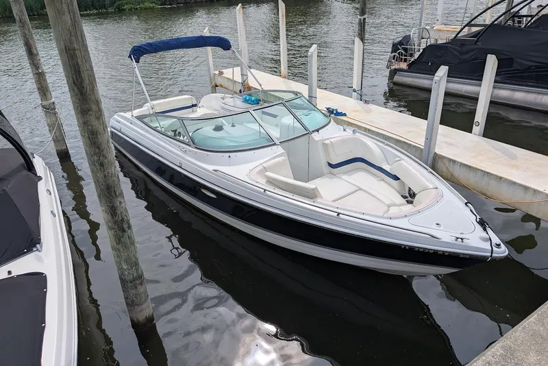 Slide: The Image of 2005 Formula 260 Bowrider boat docked in a marina, featuring sleek design and spacious seating. - 10