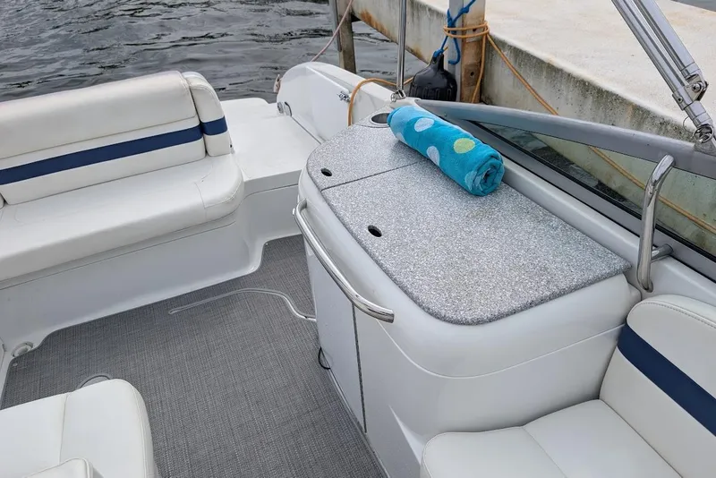 Slide: The Image of 2005 Formula 260 Bowrider interior with seating and a colorful towel on deck. - 20