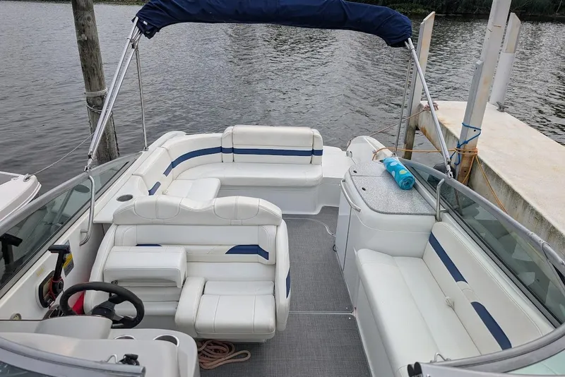 Slide: The Image of 2005 Formula 260 Bowrider with white seating, docked by the water. - 22