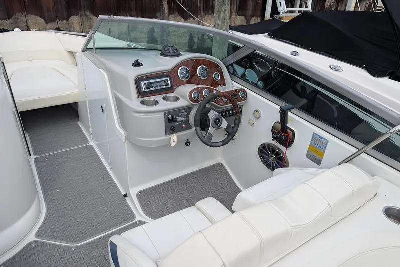 Slide: The Image of 2005 Formula 260 Bowrider boat interior with steering wheel and dashboard controls. - 24