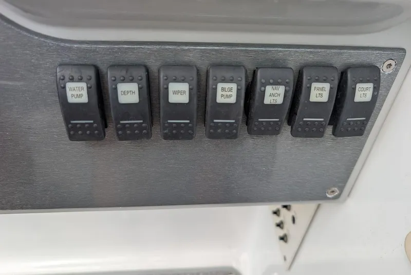 Slide: The Image of Control panel switches on a 2005 Formula 260 Bowrider boat dashboard. - 26