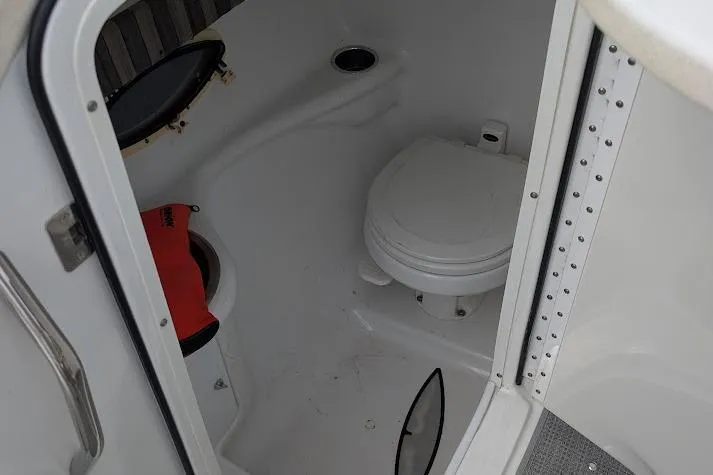 Slide: The Image of 2005 Formula 260 Bowrider boat bathroom with toilet and life jacket. - 28