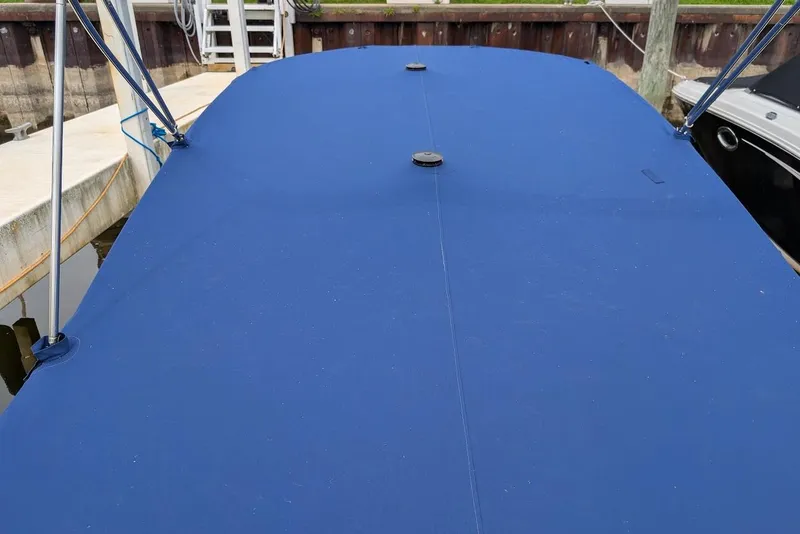 Slide: The Image of 2005 Formula 260 Bowrider with blue cover docked at marina. - 29