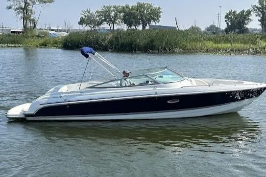 Slide: The Image of 2005 Formula 260 Bowrider boat cruising on a calm lake. - 5