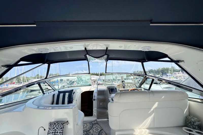 Slide: The Image of Interior view of 2002 Cruisers Yachts 3870 Express, featuring helm and seating area. - 10