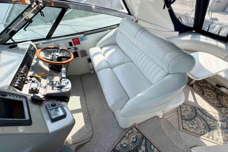 Slide: The Image of 2002 Cruisers Yachts 3870 Express cockpit with leather seating and modern controls. - 11