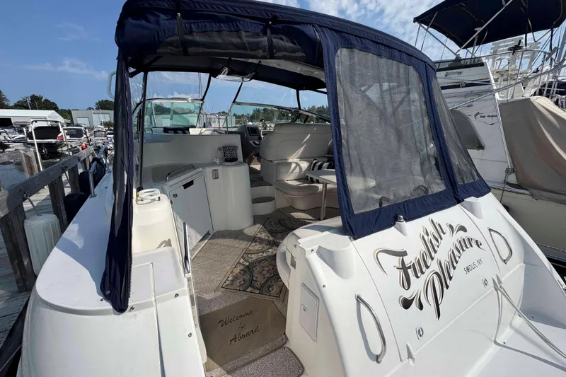 Slide: The Image of 2002 Cruisers Yachts 3870 Express docked, featuring spacious cockpit and elegant interior design. - 2