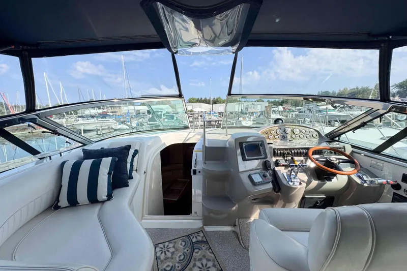 Slide: The Image of 2002 Cruisers Yachts 3870 Express cockpit with luxurious seating and modern controls. - 20