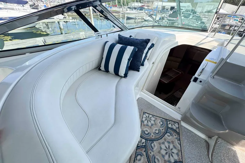 Slide: The Image of 2002 Cruisers Yachts 3870 Express interior with white seating and decorative pillows. - 22