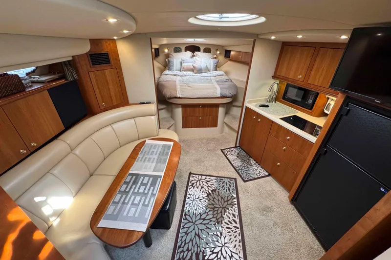 Slide: The Image of Luxurious interior of 2002 Cruisers Yachts 3870 Express with kitchen, dining, and sleeping area. - 23