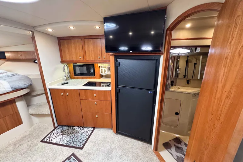 Slide: The Image of Luxurious 2002 Cruisers Yachts 3870 Express interior with kitchenette and bathroom. - 24