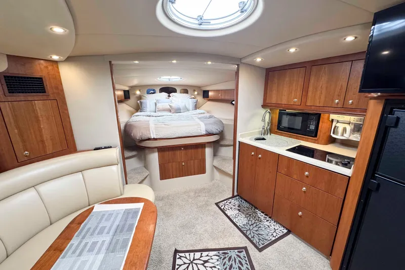 Slide: The Image of Luxurious interior of 2002 Cruisers Yachts 3870 Express with cozy bed and modern kitchenette. - 25