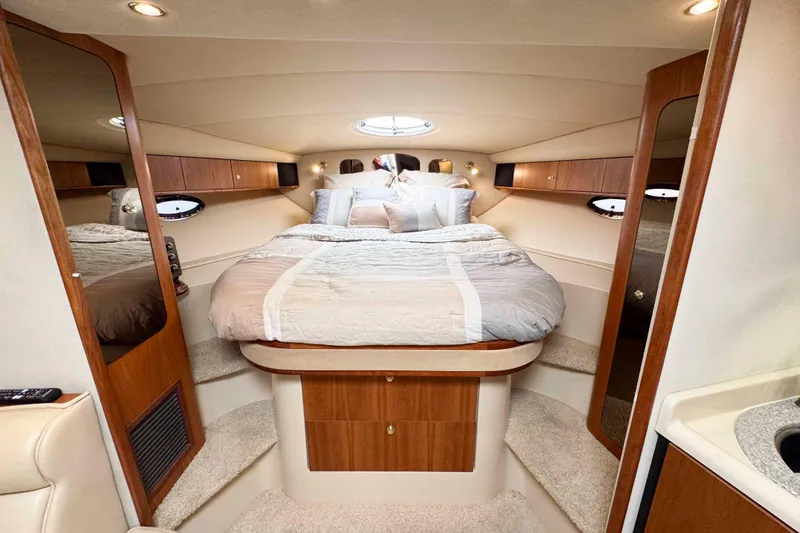 Slide: The Image of Luxurious interior of 2002 Cruisers Yachts 3870 Express with cozy bed and elegant wood finish. - 27