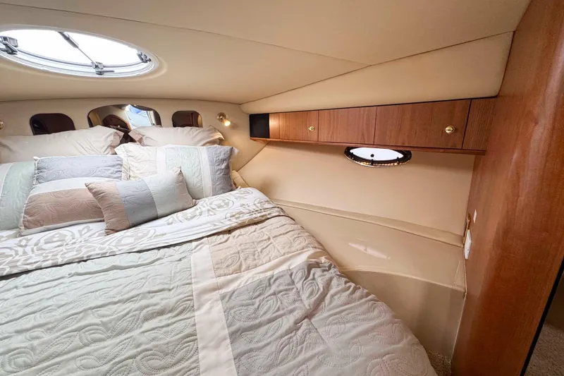 Slide: The Image of Luxurious cabin interior of 2002 Cruisers Yachts 3870 Express with elegant bedding and wood accents. - 28