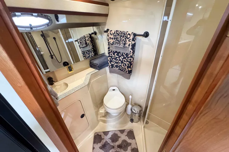 Slide: The Image of Luxurious bathroom in 2002 Cruisers Yachts 3870 Express with elegant fixtures and leopard print towels. - 29