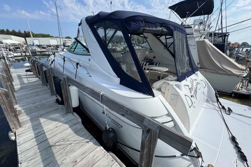 Slide: The Image of 2002 Cruisers Yachts 3870 Express docked at marina under blue sky. - 3
