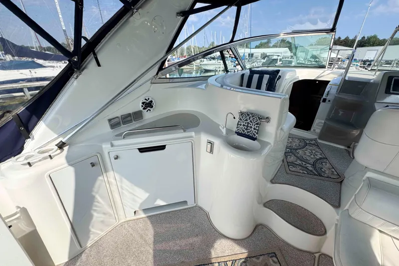 Slide: The Image of 2002 Cruisers Yachts 3870 Express interior with seating, sink, and nautical decor. - 8