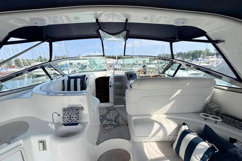 Slide: The Image of Interior of 2002 Cruisers Yachts 3870 Express with plush seating and nautical decor. - 9