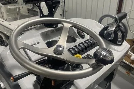 Slide: The Image of 2021 Young Boats Gulfshore 22 center console, parked outdoors on a sunny day. - 12