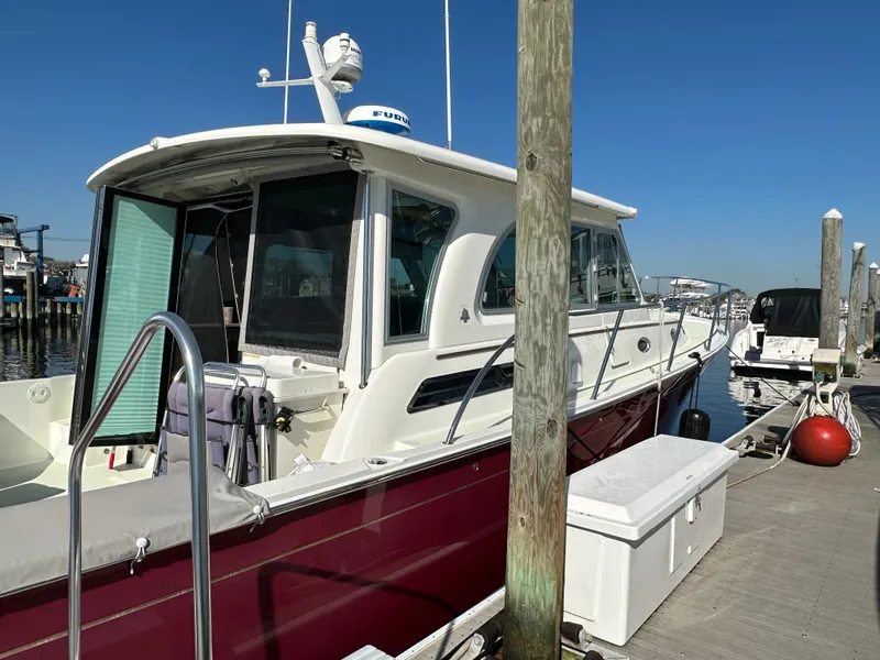 Slide: The Image of 2017 Back Cove 41 boat docked at marina with clear blue sky. - 10