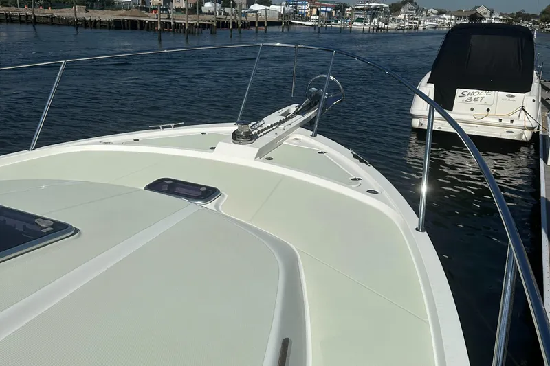 Slide: The Image of 2017 Back Cove 41 boat docked in a marina, showcasing its sleek bow design. - 15