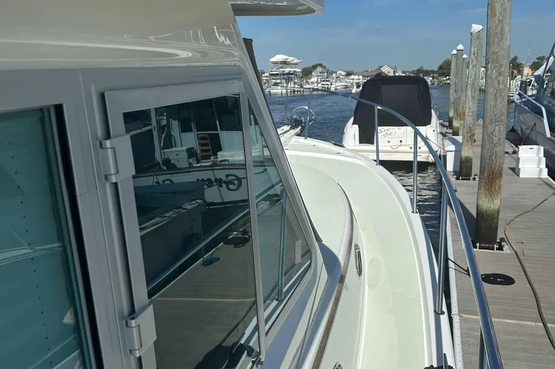 Slide: The Image of 2017 Back Cove 41 yacht docked at a marina, showcasing sleek design and waterfront view. - 18