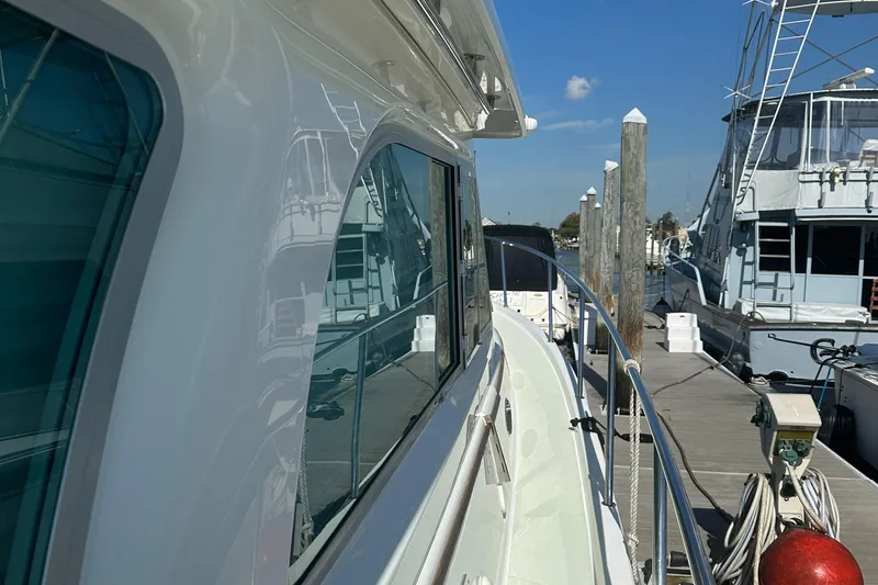 Slide: The Image of 2017 Back Cove 41 yacht docked at marina, side view with clear blue sky. - 19