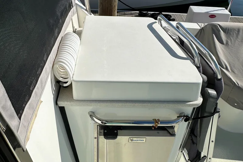 Slide: The Image of 2017 Back Cove 41 boat deck with storage compartment and coiled hose. - 22