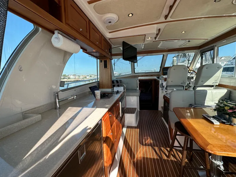 Slide: The Image of 2017 Back Cove 41 yacht interior with modern kitchen, seating, and helm station. - 29