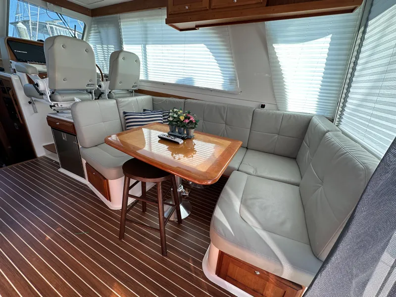 Slide: The Image of Luxurious interior of 2017 Back Cove 41 yacht with plush seating and elegant table. - 31