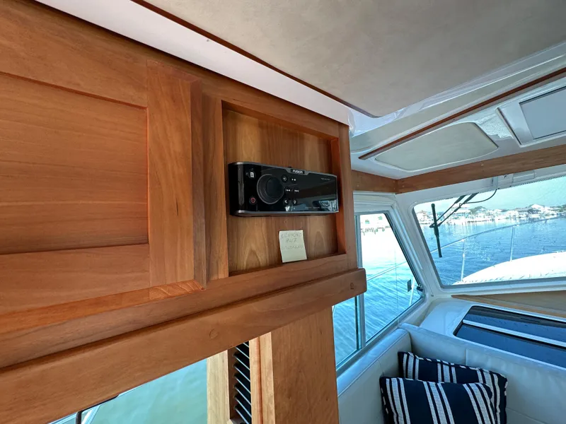 Slide: The Image of Interior of 2017 Back Cove 41 yacht with wooden paneling and striped cushions. - 32