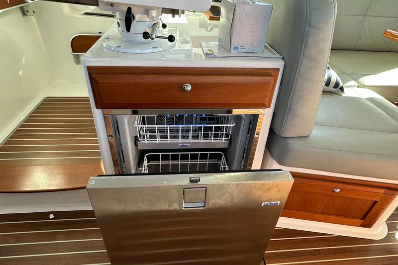 Slide: The Image of 2017 Back Cove 41 yacht interior with open dishwasher and wooden cabinetry. - 38