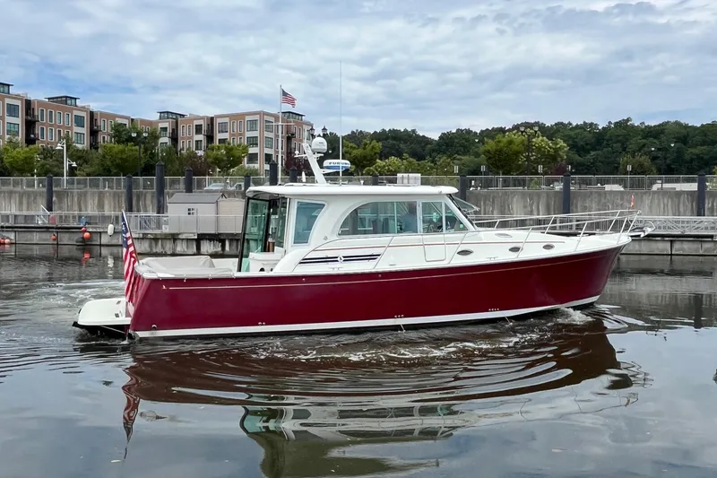 Slide: The Image of 2017 Back Cove 41 boat with red hull docked in a marina. - 4