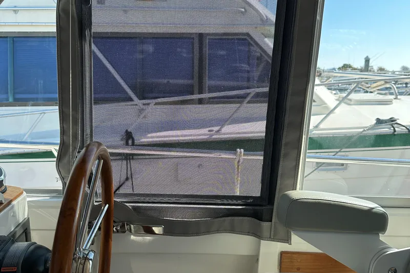 Slide: The Image of Interior view of 2017 Back Cove 41 yacht helm with mesh window screen. - 45