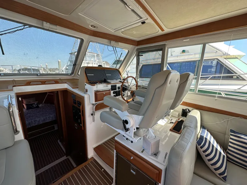 Slide: The Image of Interior of 2017 Back Cove 41 yacht with helm station and seating area. - 48