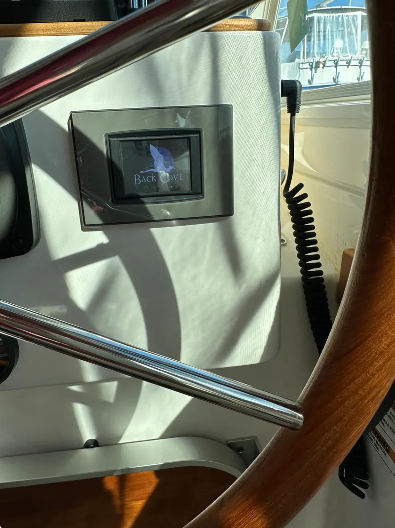 Slide: The Image of Steering wheel and control panel of 2017 Back Cove 41 boat. - 49