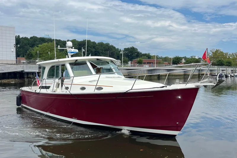 Slide: The Image of 2017 Back Cove 41 boat with red hull docked in a marina. - 5