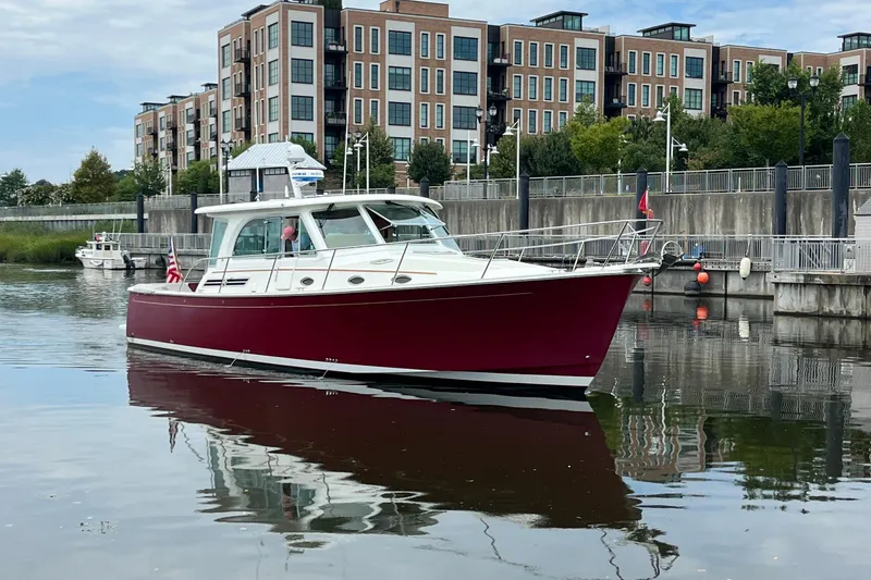 Slide: The Image of 2017 Back Cove 41 boat docked near modern waterfront buildings. - 6