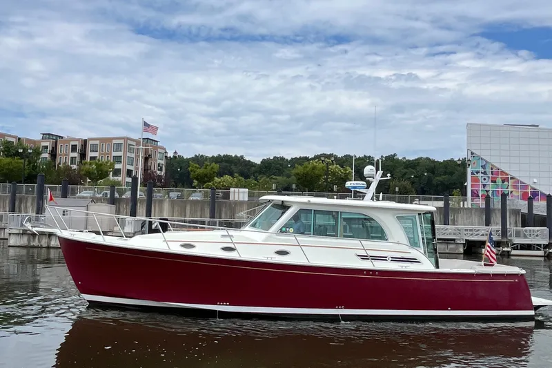 Slide: The Image of 2017 Back Cove 41 boat with red hull docked in a marina. - 7