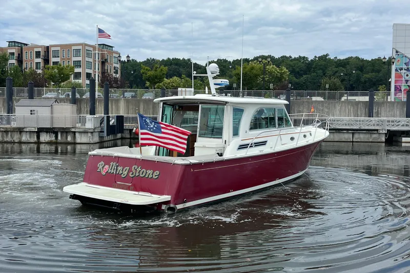 Slide: The Image of 2017 Back Cove 41 boat with American flag, docked in a marina. - 9