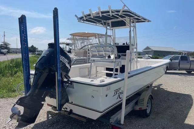 Slide: The Image of 2007 KenCraft 2260 BAYRIDER boat on trailer with outboard motor, parked outdoors. - 1