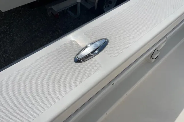 Slide: The Image of 2007 KenCraft 2260 BAYRIDER boat detail with chrome cleat on textured surface. - 14